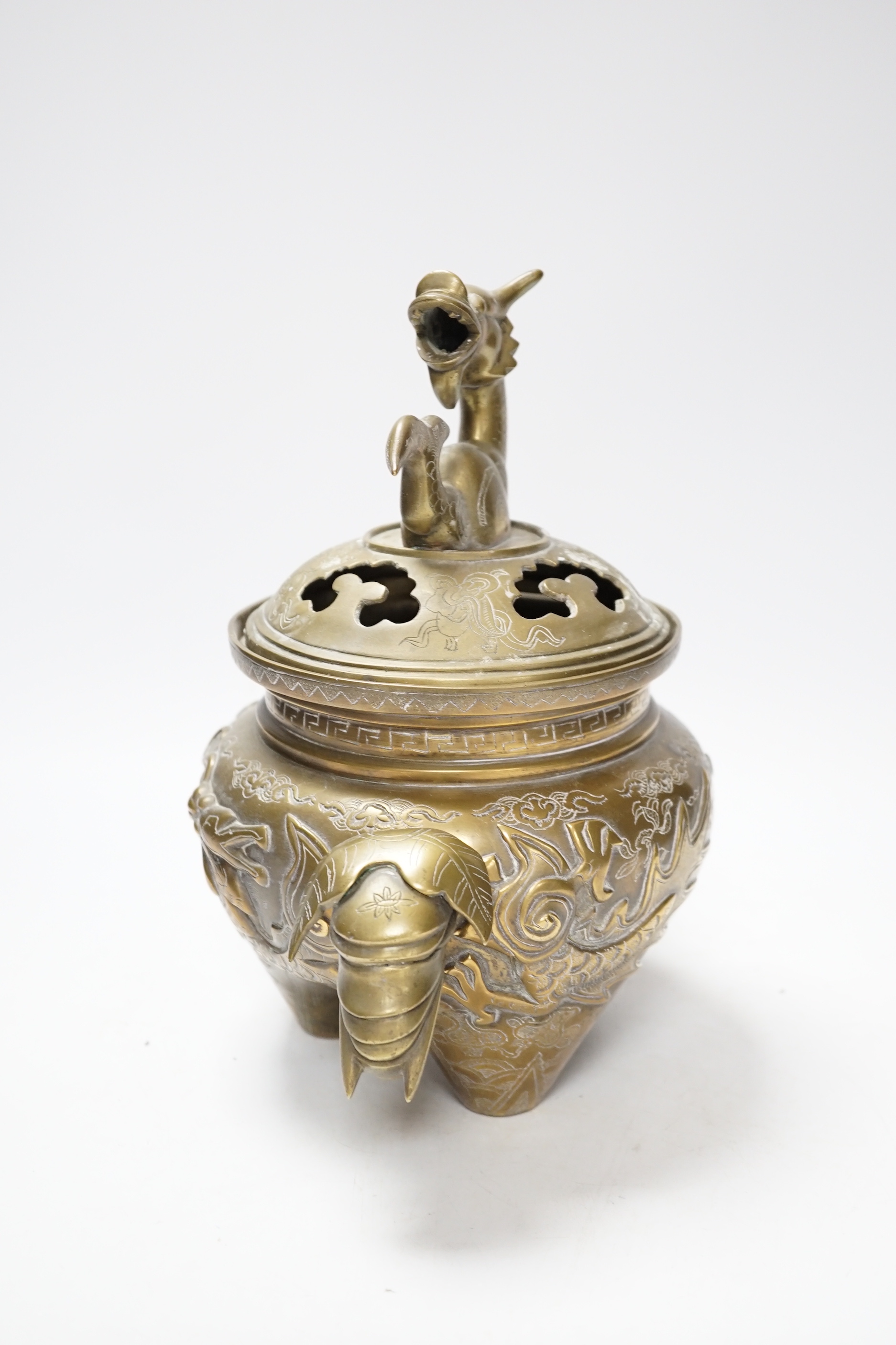 A Chinese bronze ‘dragon’ tripod censer and cover, 24cm